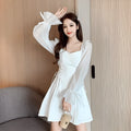 White chiffon patchwork dress with long sleeves and a slim, waist-defining fit on a mannequin.