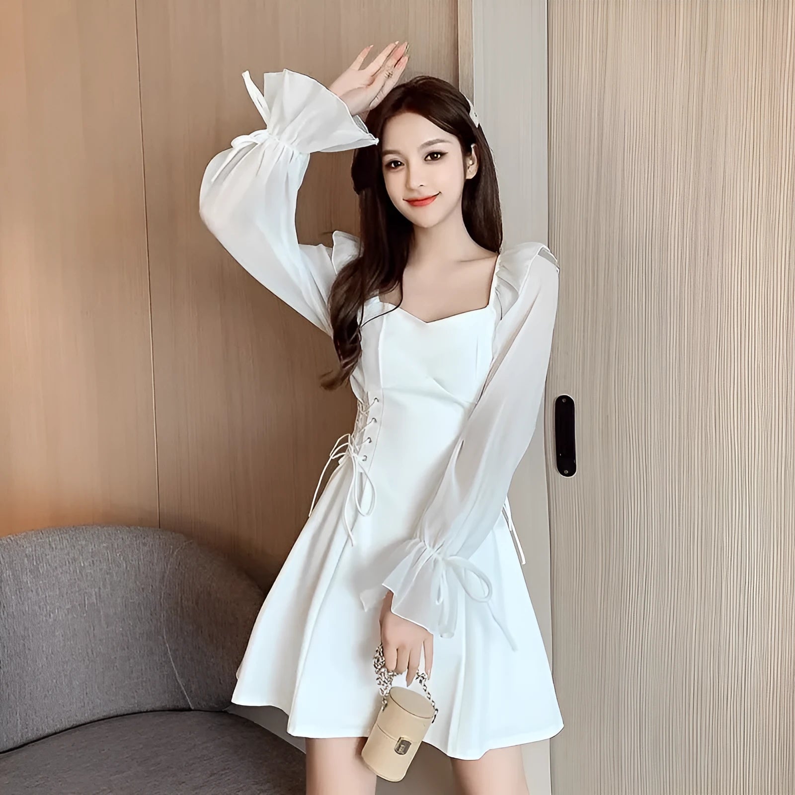 White chiffon patchwork dress with long sleeves and a slim, waist-defining fit on a mannequin.