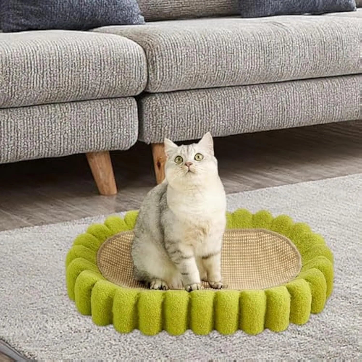 Green oval cat scratcher pad and bed made from sisal, measuring 65cm long.