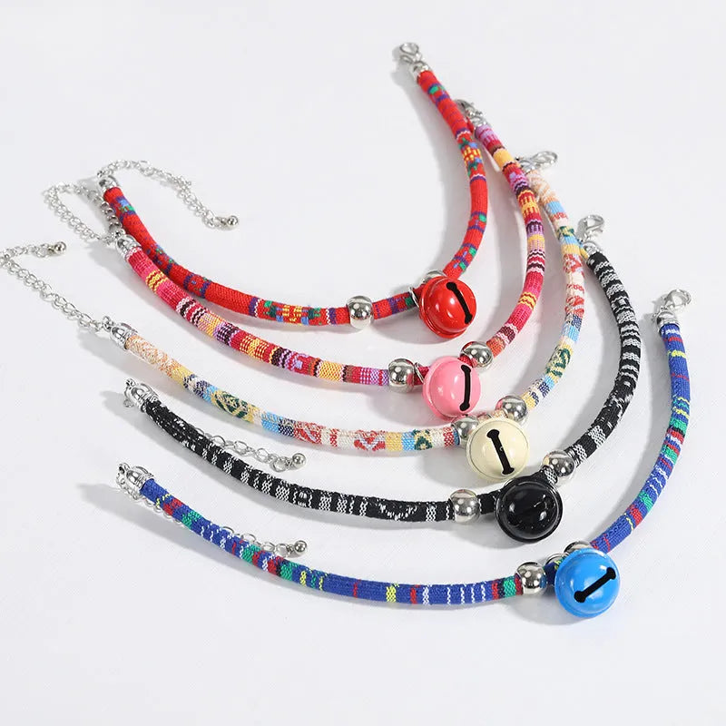 Colourful ethnic style adjustable dog collar with a bell, shown in multiple colour options.
