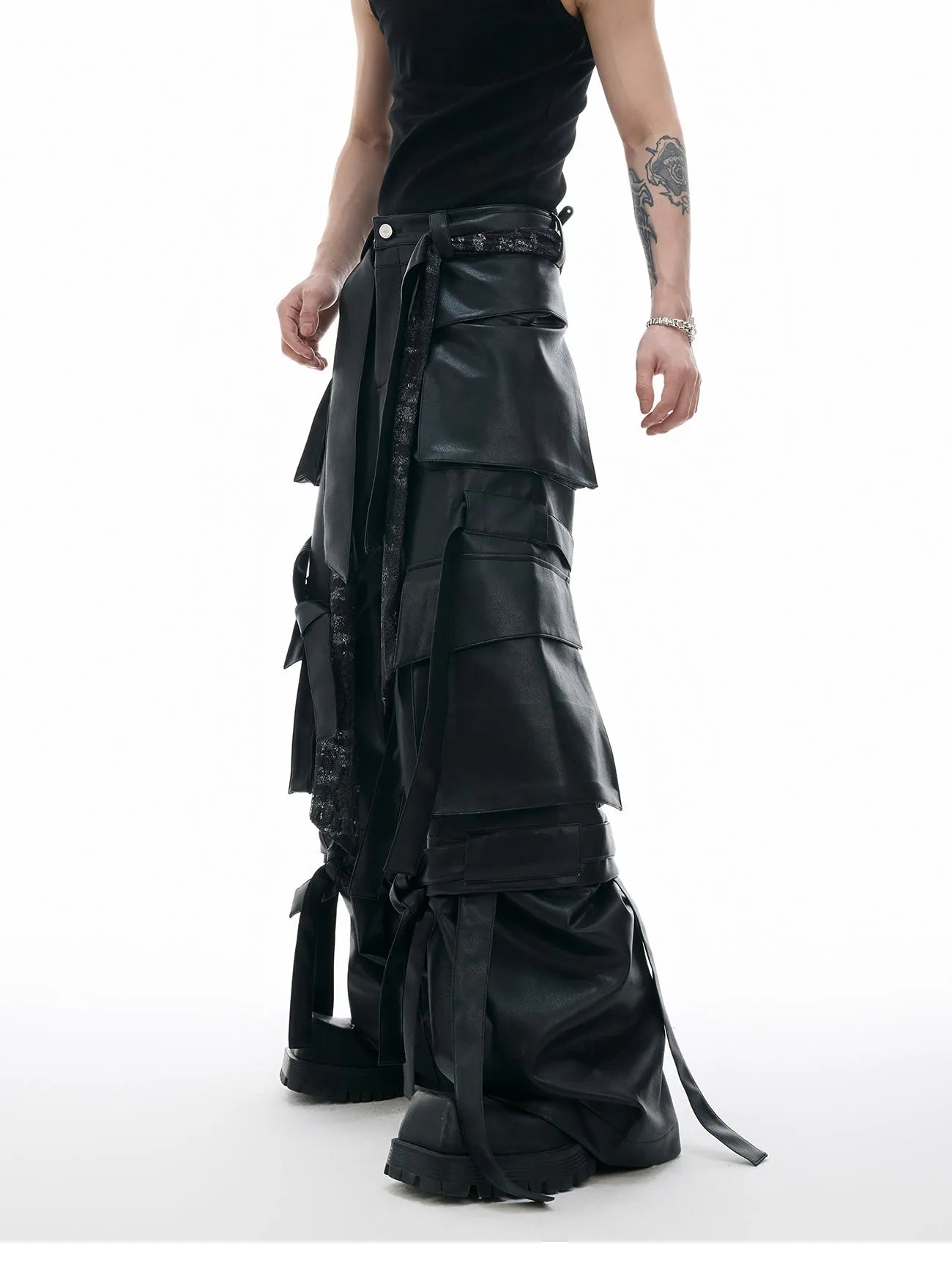 Black loose-fit retro leather pants with quilted panels and multiple pockets.