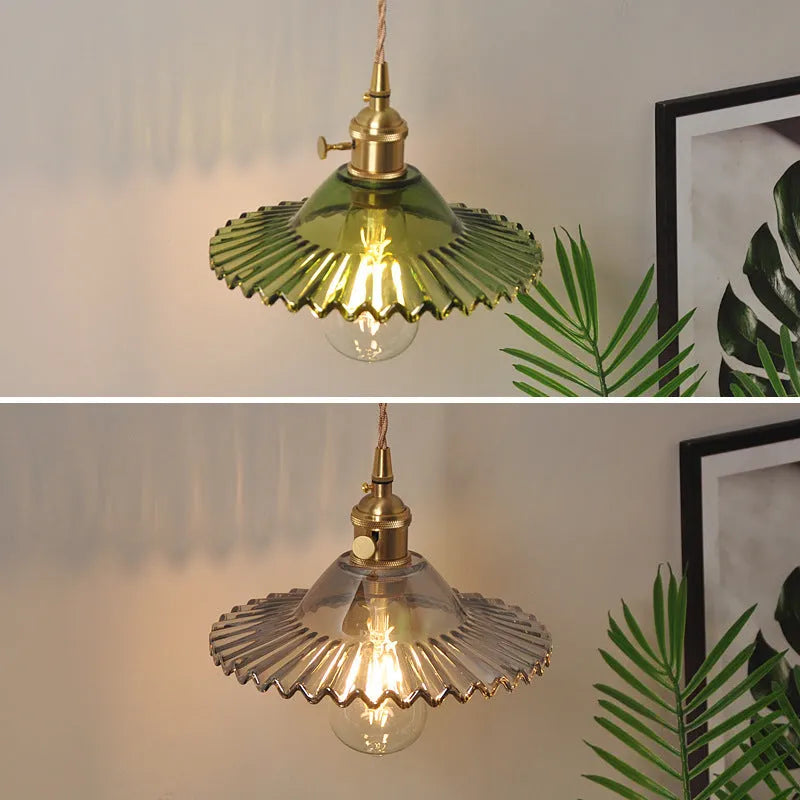 Retro brass wall lamp with lotus-shaped glass shade in choice of colours, mounted on a wall.