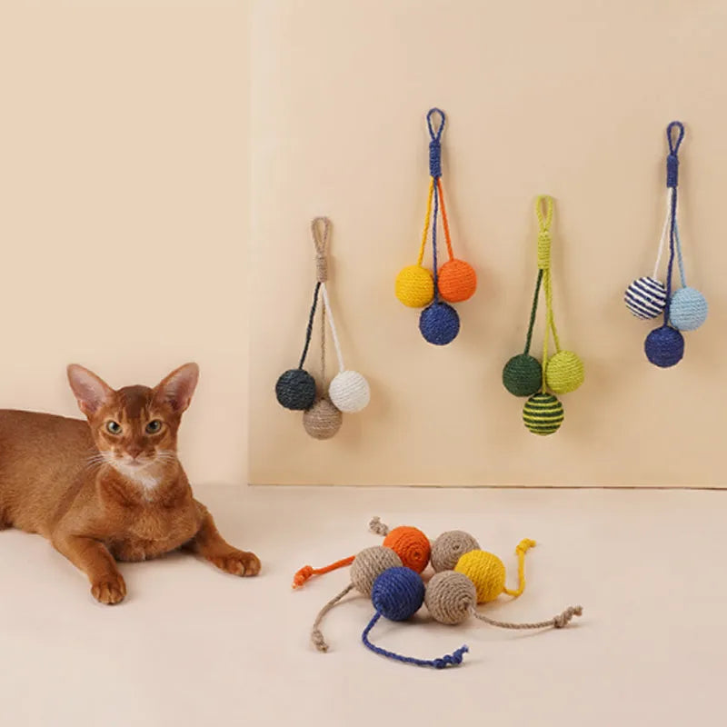 Four-piece cat toy set with teaser stick, catnip ball, and self-play toys on blue background