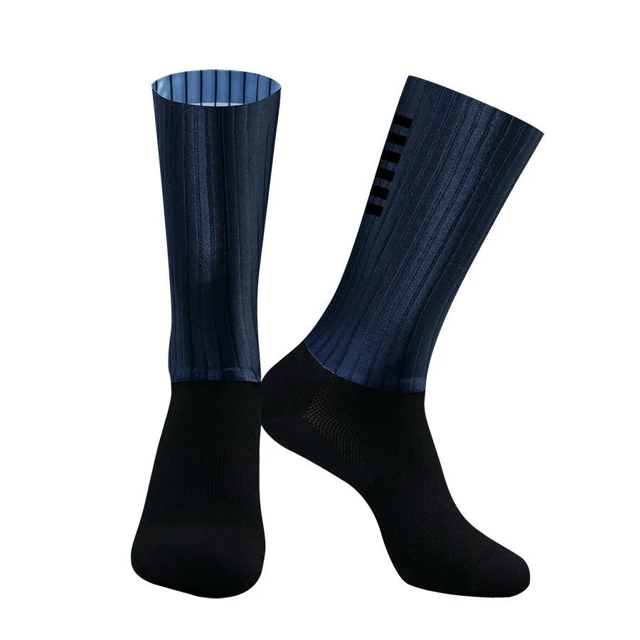 A pair of athletic cycling and running socks in a moisture-wicking fabric blend on a grey background.