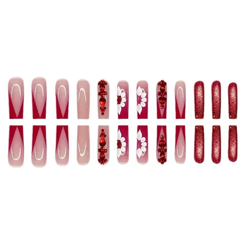Long European square fake nails with red diamond and flower pattern design, shown with glue and file