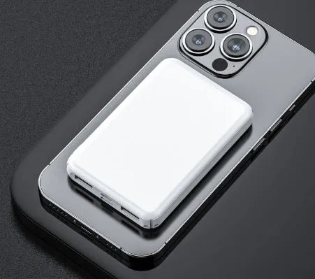 Black rectangular electric heating vest power bank with USB port, shown next to a measuring tape.