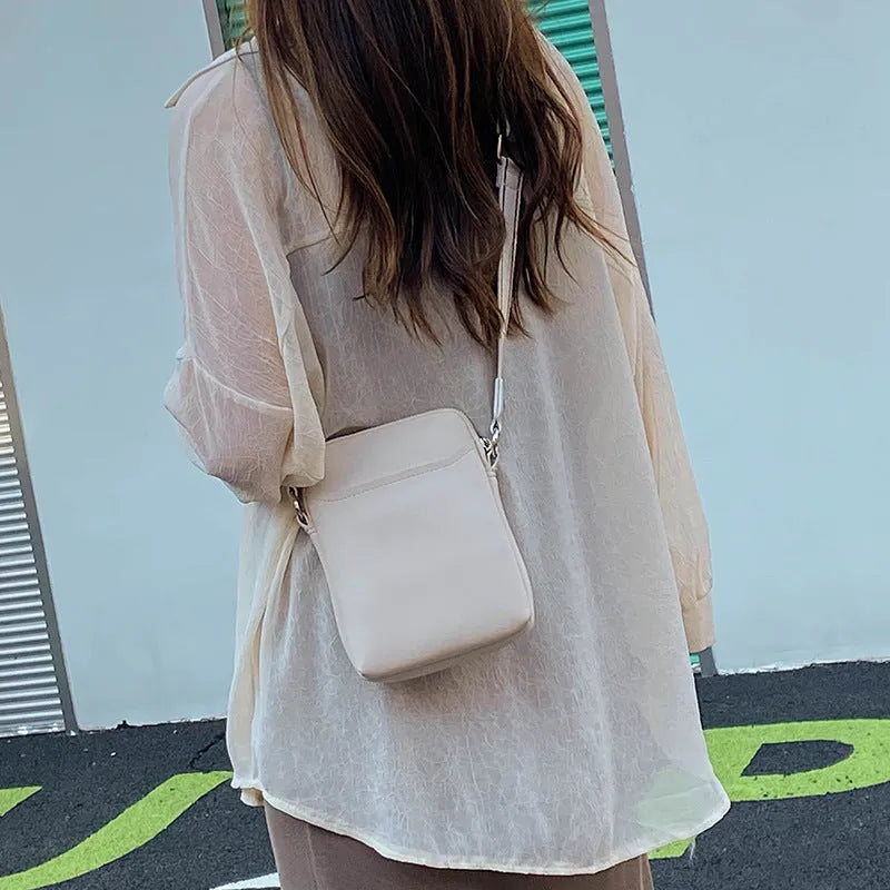 Solid colour PU mobile phone crossbody shoulder bag in black, beige, khaki, or green.