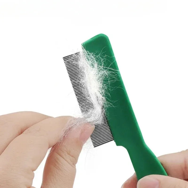 Green plastic handle stainless steel pet flea comb for dogs and cats on a plain background.