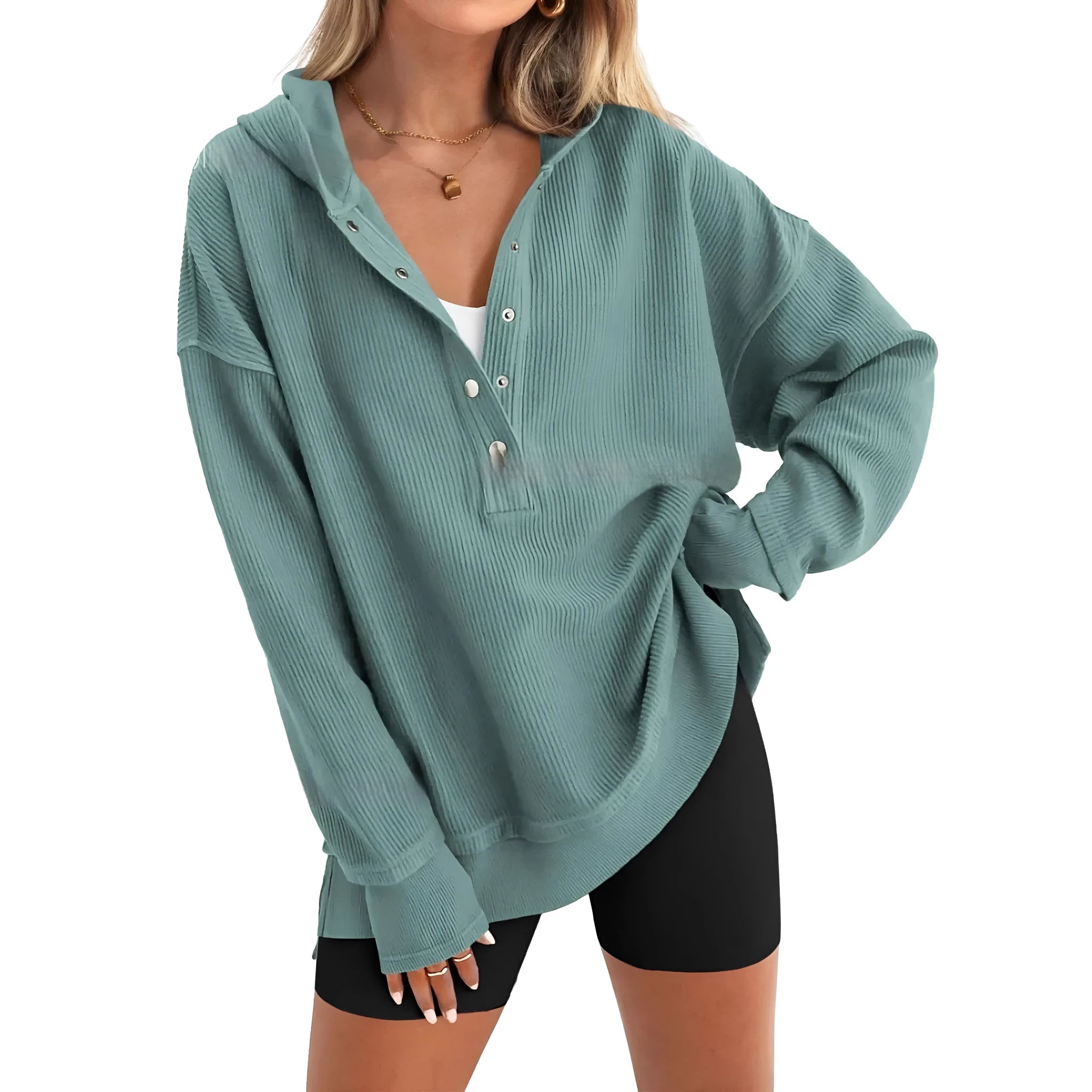A peacock green women's loose fit pullover sweater with raglan sleeves on a hanger.
