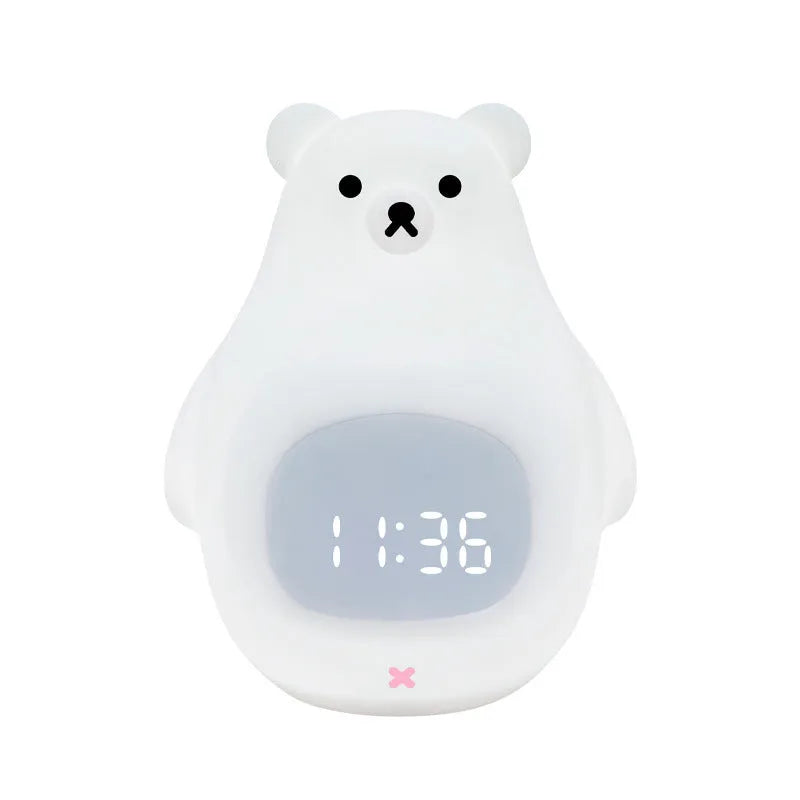 White silicone cartoon bear night light with remote control on a table.