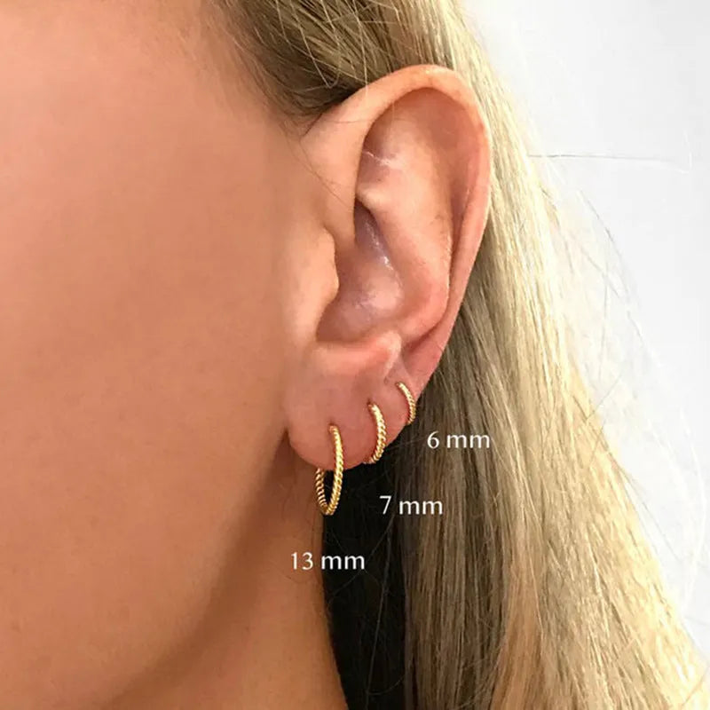 Twisted sterling silver round ring earrings in gold and white gold finishes showing multiple sizes