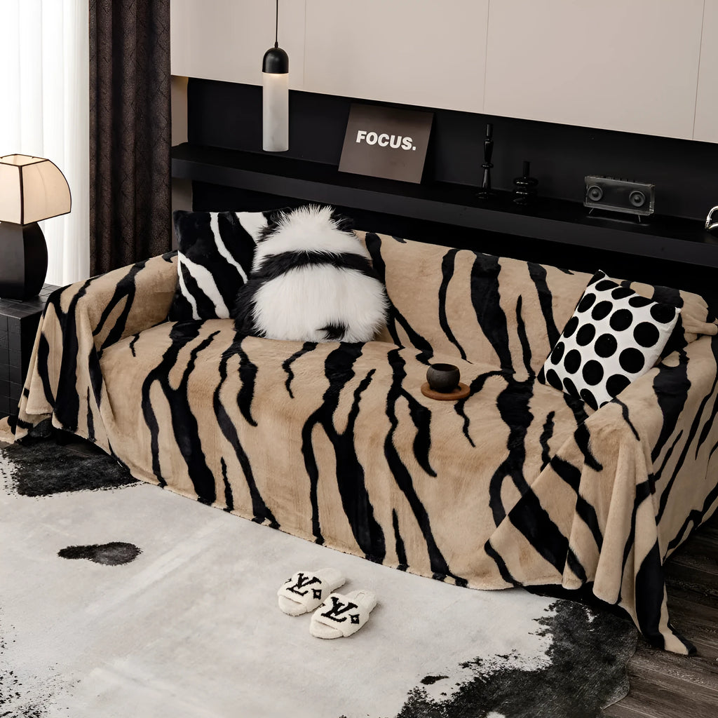 Zebra pattern flannel sofa slipcover in caramel colour, shown on a grey sofa