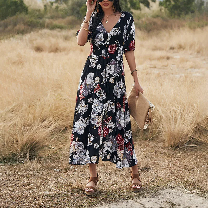 Yellow floral print women's summer dress with V-neck and elastic waist on a hanger