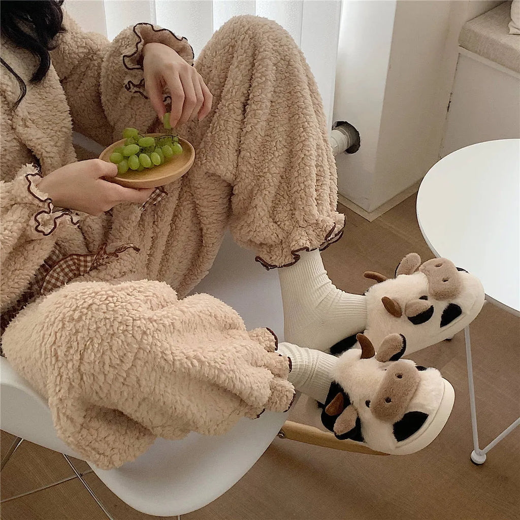 White women's cow slippers with plush faux fur upper and textured non-slip soles