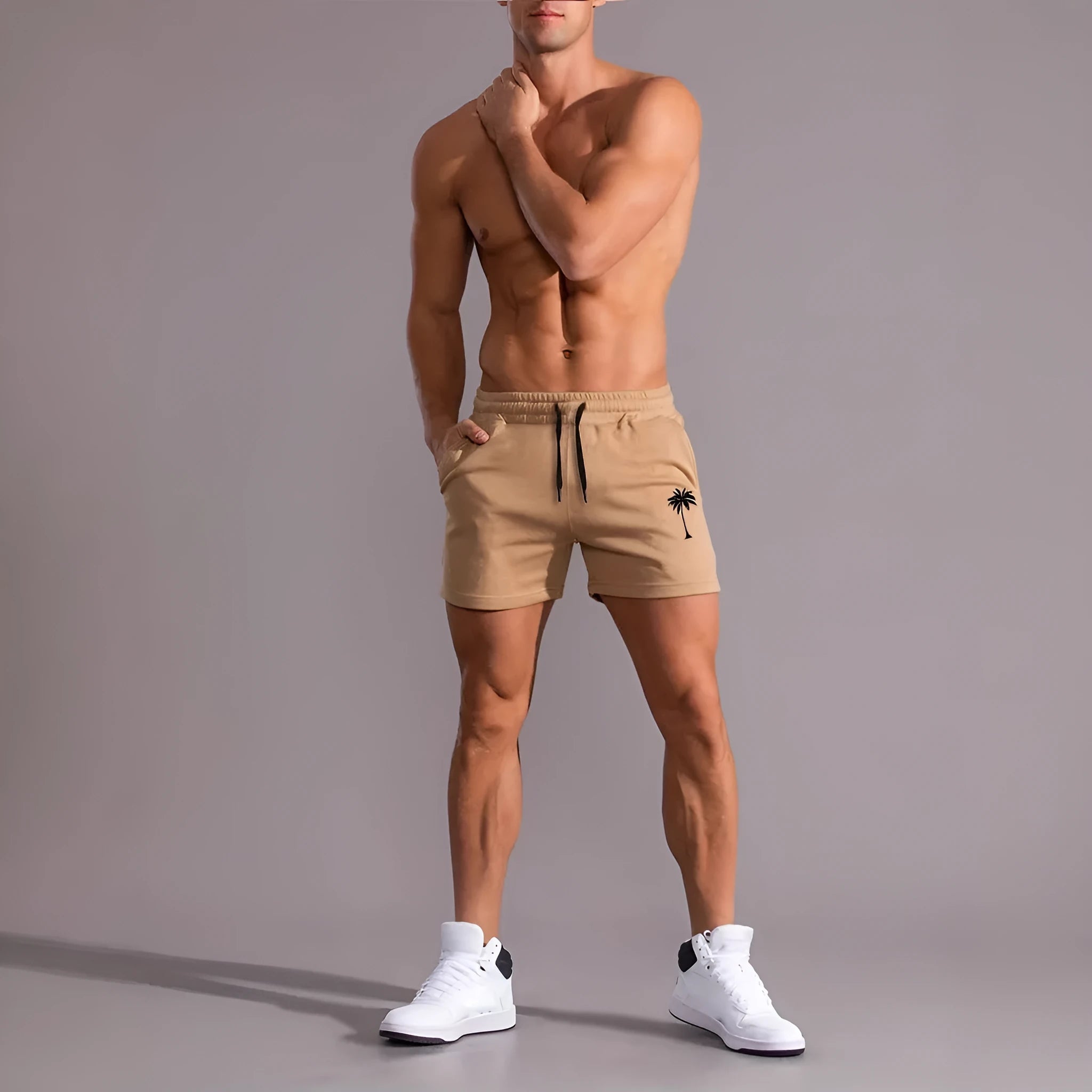 Khaki men's sports shorts with a white coconut leaf print, showing straight leg fit.