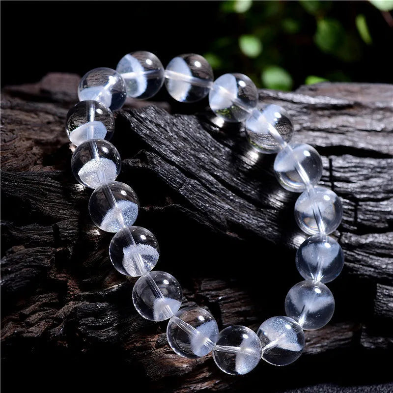 Women's white crystal pyramid bead bracelet with Ruyi element on wrist