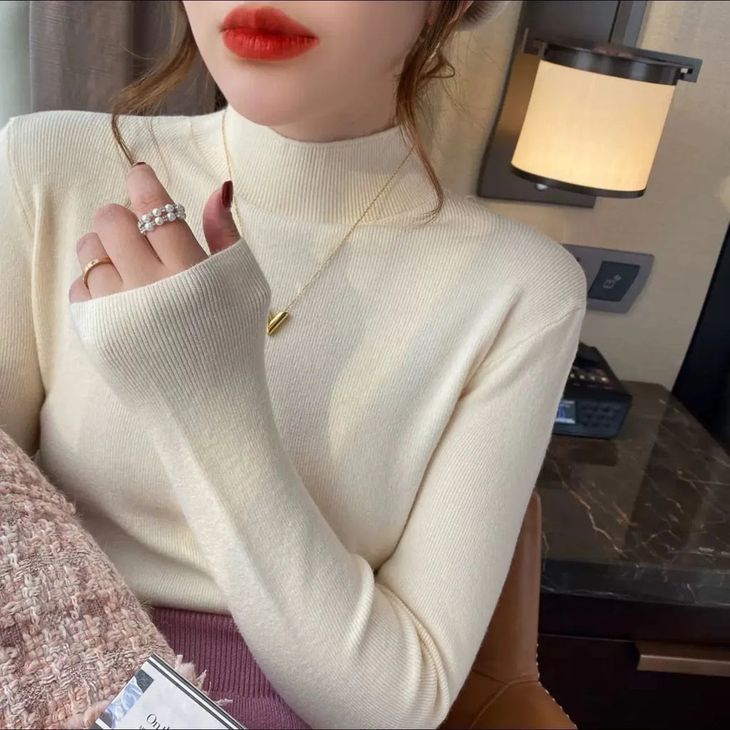 Women's slim fit long sleeve knitted pullover top in viscose fibre, shown in apricot colour.