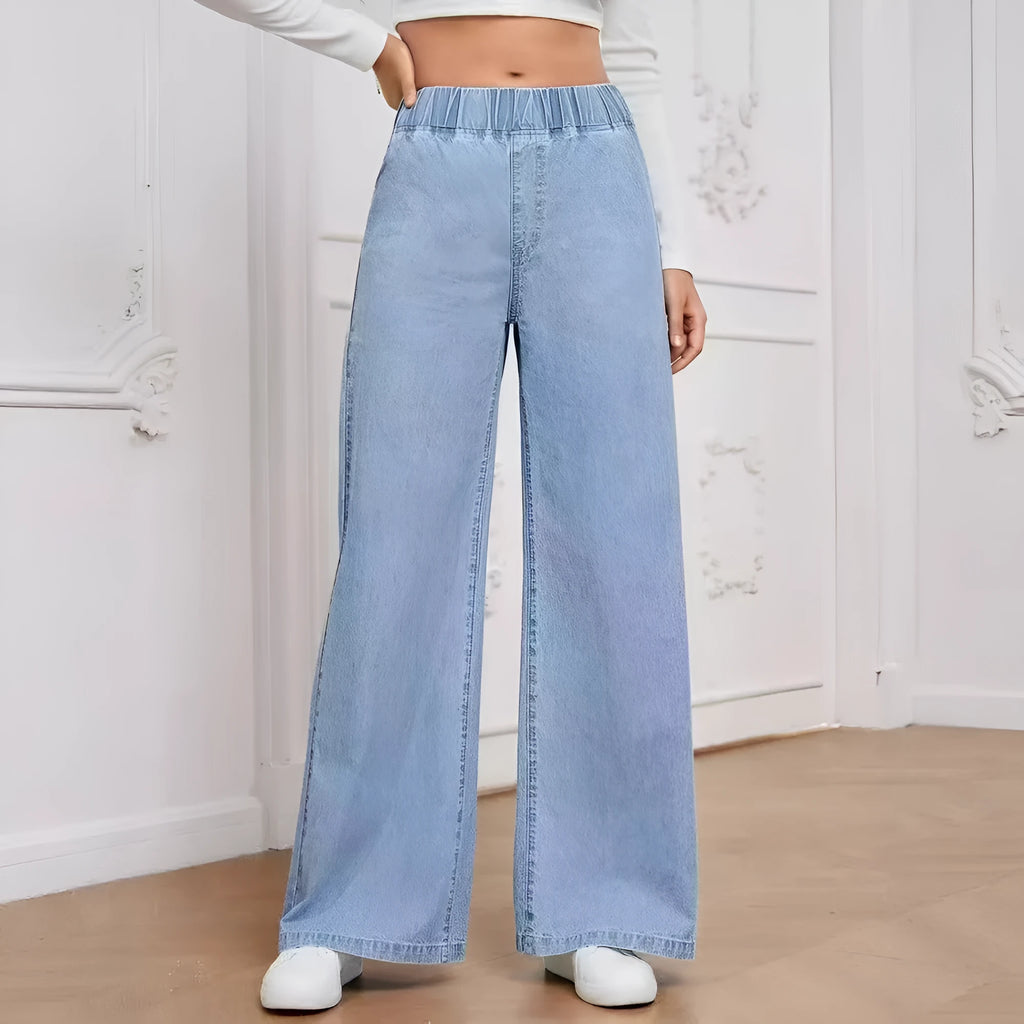 Plus size light blue washed wide-leg denim jeans on a hanger, showing straight leg cut.