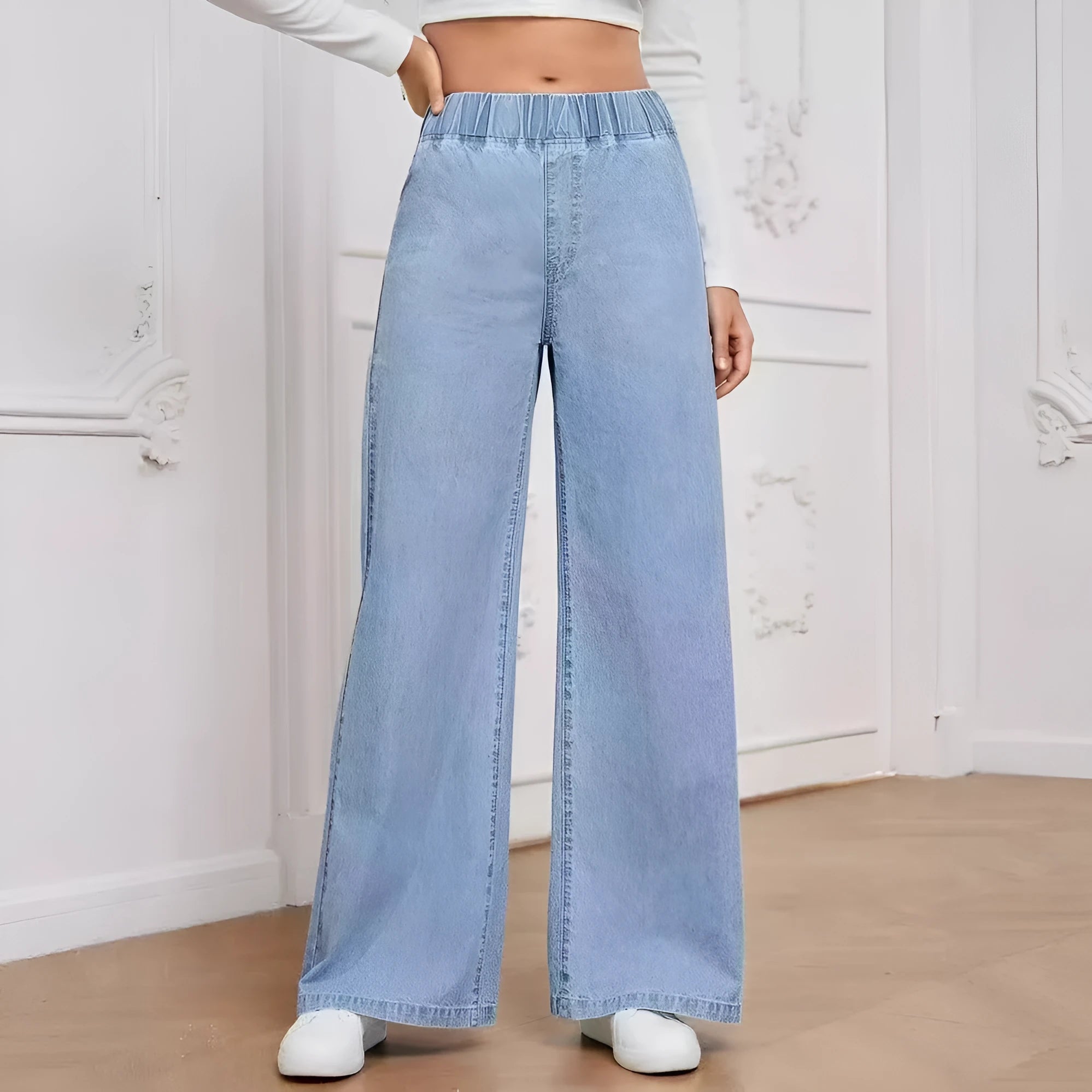 Plus size light blue washed wide-leg denim jeans on a hanger, showing straight leg cut.