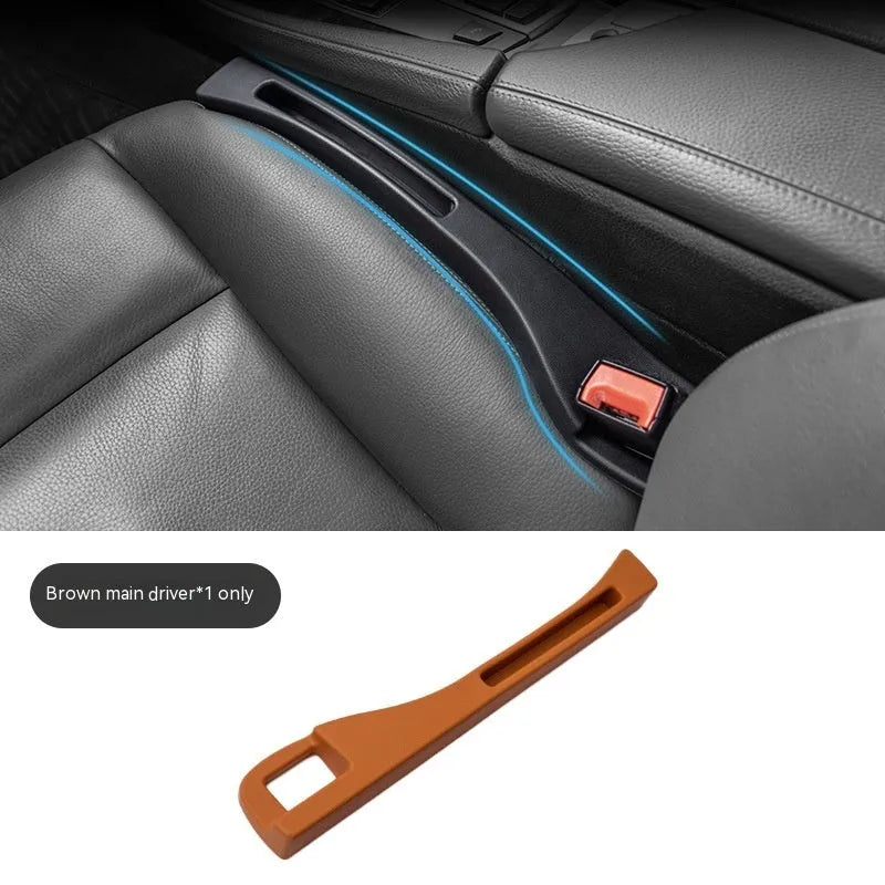 Black plastic car seat gap storage box with removal handle inserted between vehicle seats