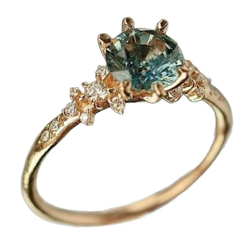 Gold plated geometric ring with a claw-set zircon stone in a chamfered square pattern.