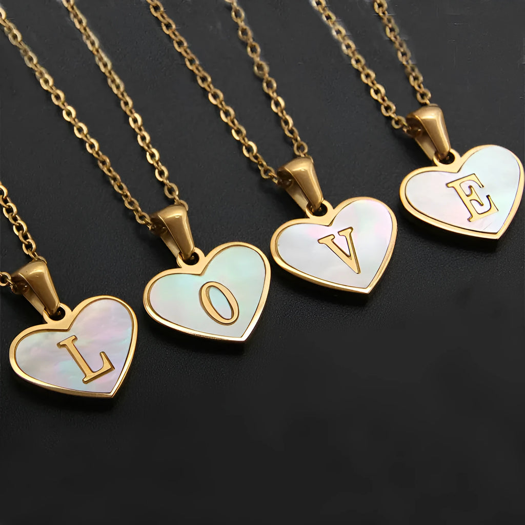 Gold chain necklace with white shell heart pendant featuring single letter customisation option