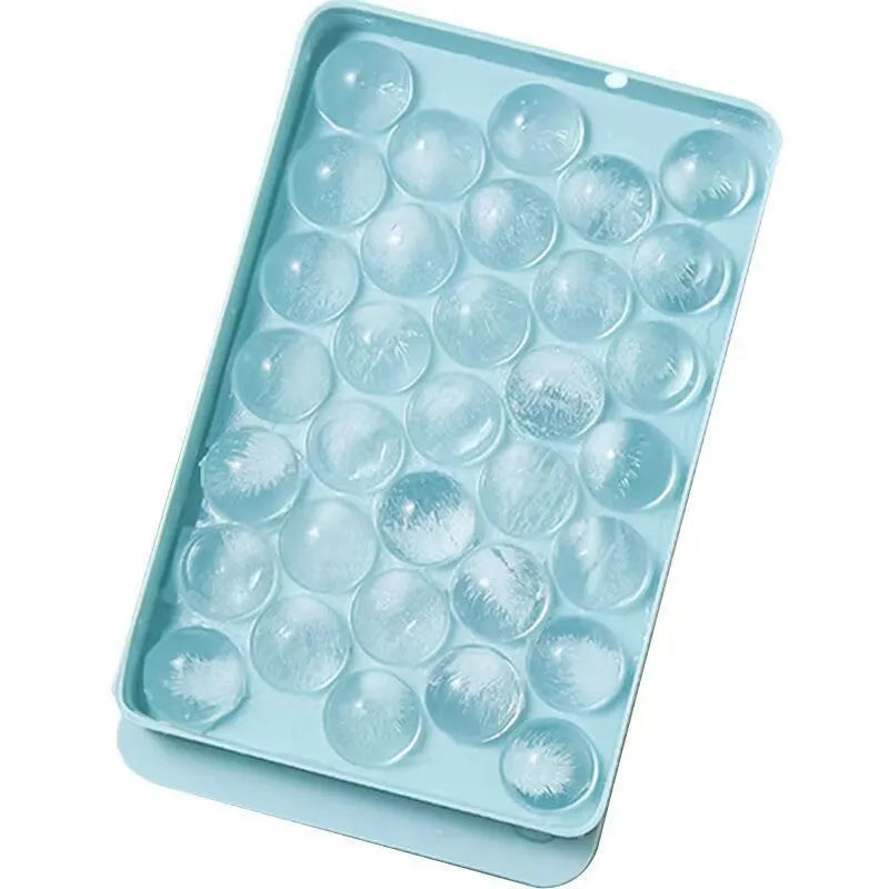 Blue silicone ice cube tray with lid showing 33 round moulds for homemade ice making