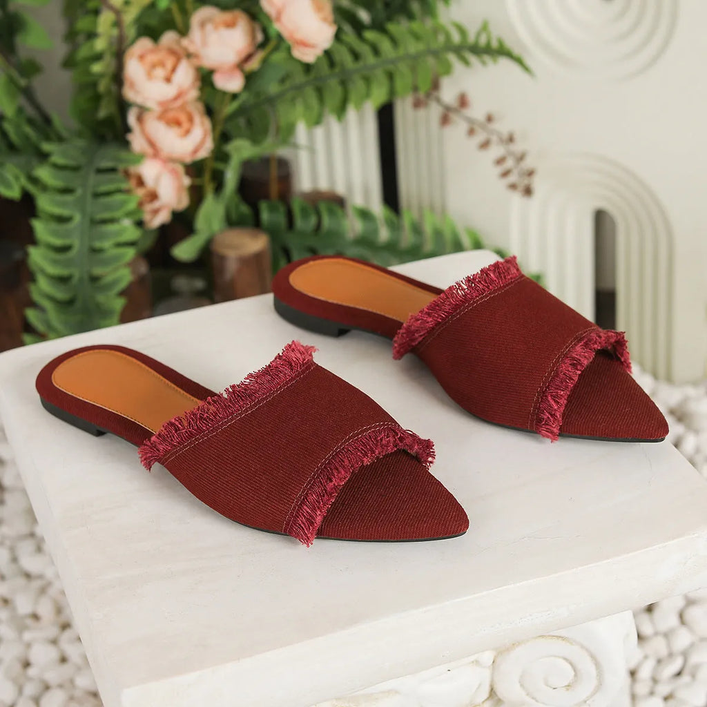 Women's denim flat slippers with tassel detail in multiple colour options.