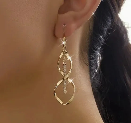 Gold-coloured spiral design alloy earrings with elliptical geometric details