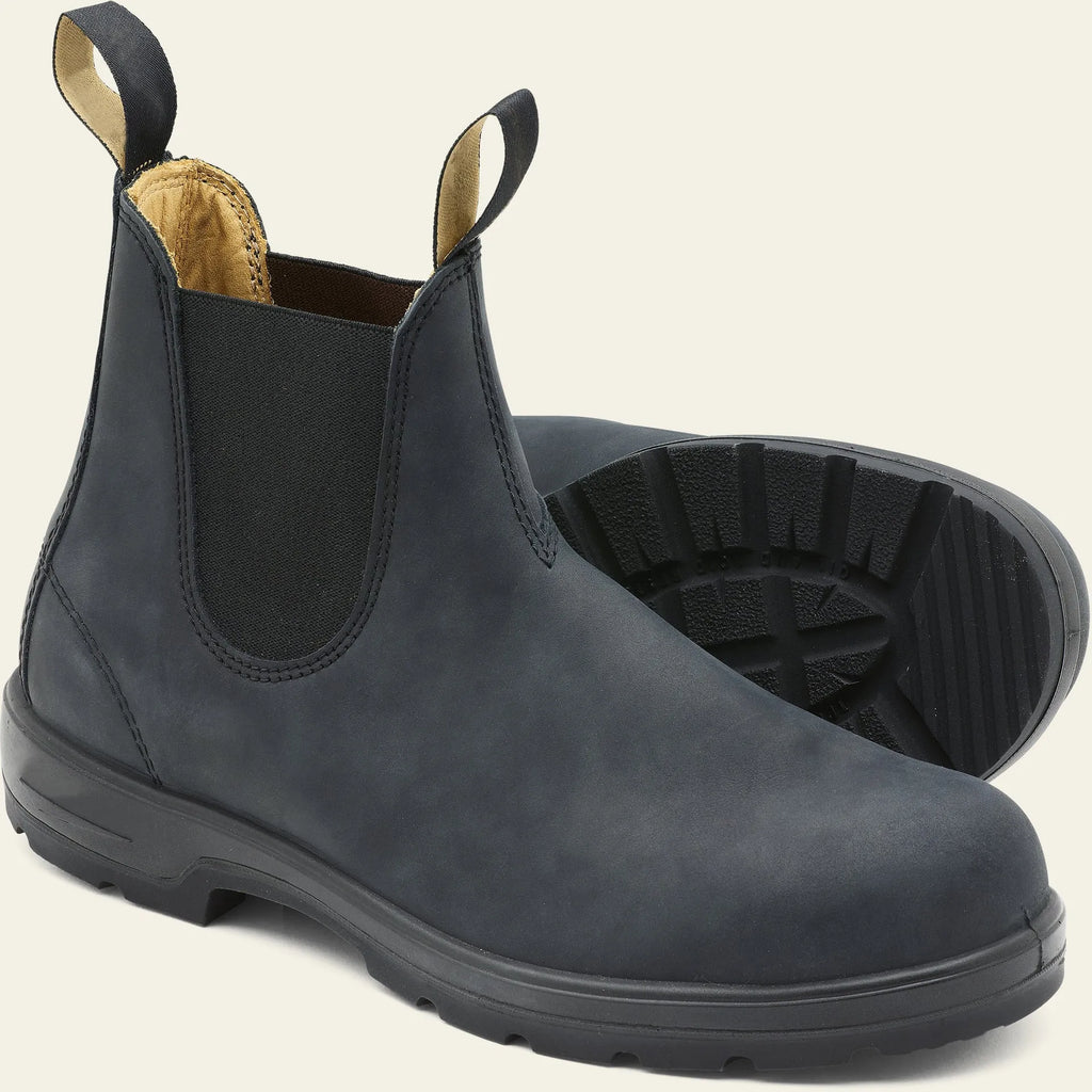 Vintage brown frosted finish Chelsea boots with car suture detailing on a wooden floor.