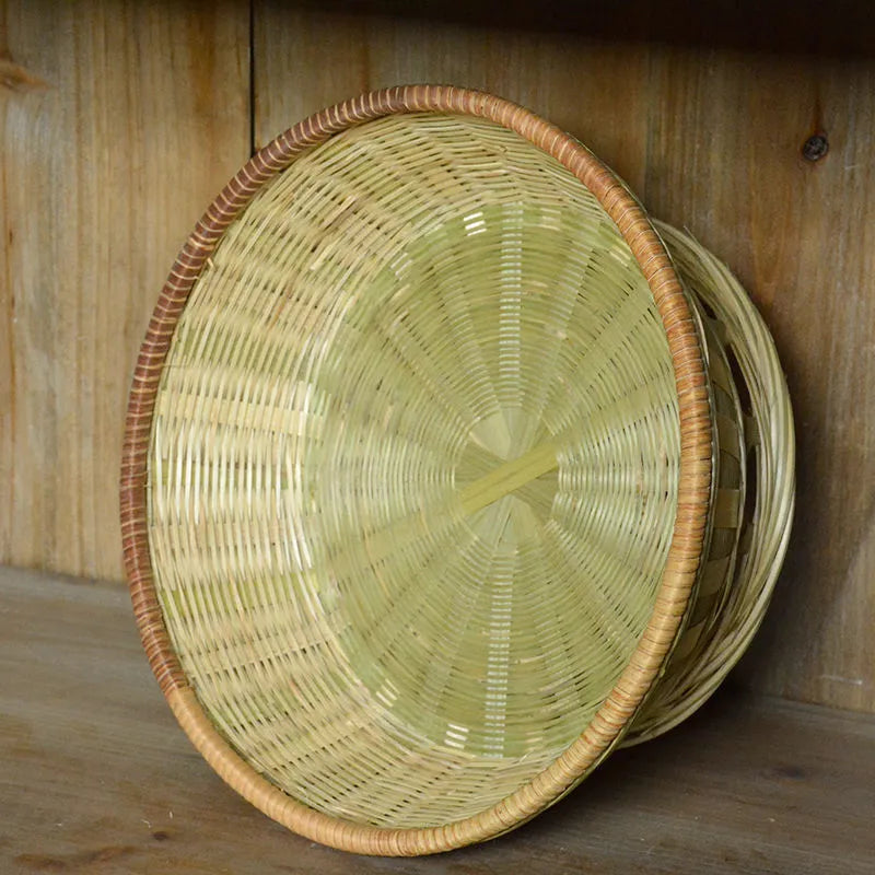 Handmade natural bamboo storage basket shown in a household setting.