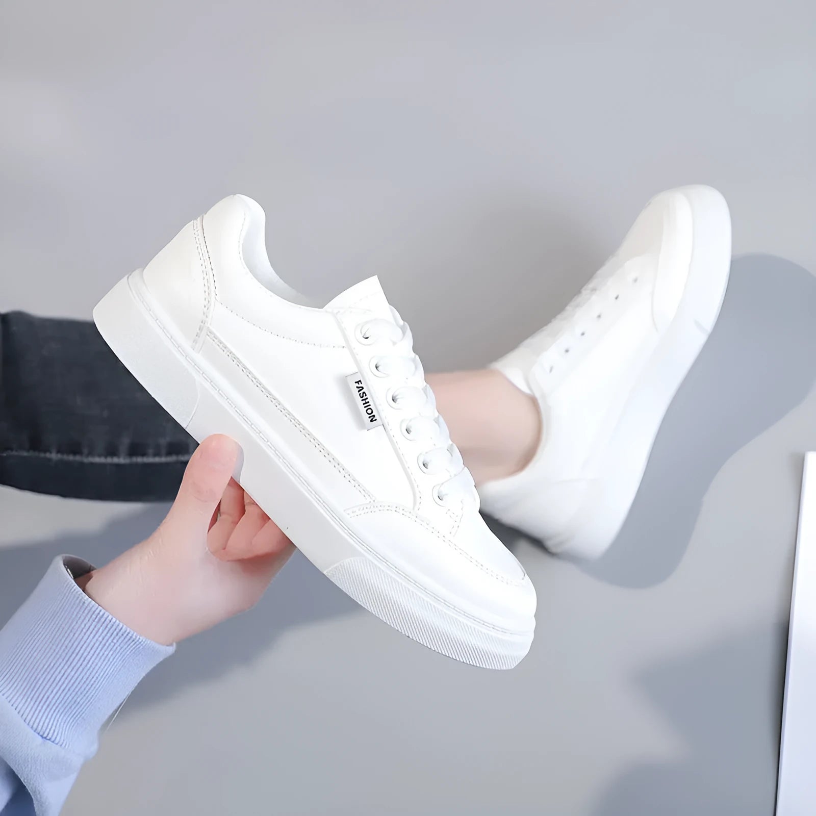 Korean style low-top women's sneakers in white and brown, showing artificial PU upper and plastic sole