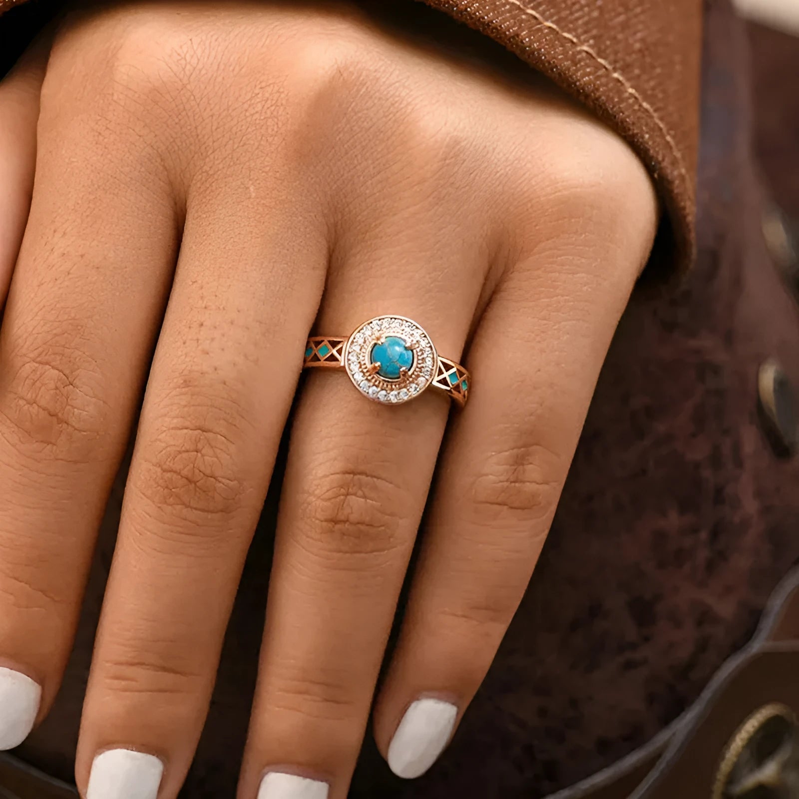 Women's rose gold coloured copper ring with geometric ethnic design and inlaid zircon detailing.
