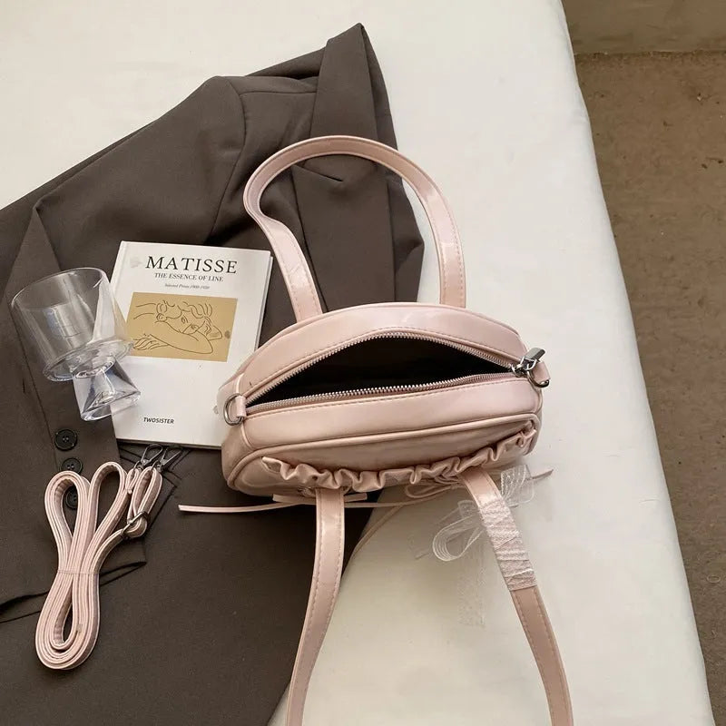 Women's fashion handbag with bandage bow design and mobile phone compartment in selected colour