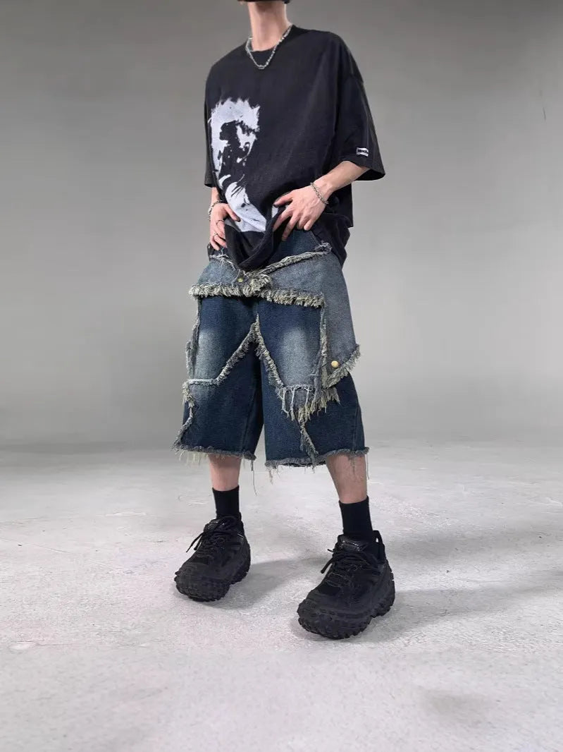 Blue denim shorts with frayed hem and star detail shown in loose fit style