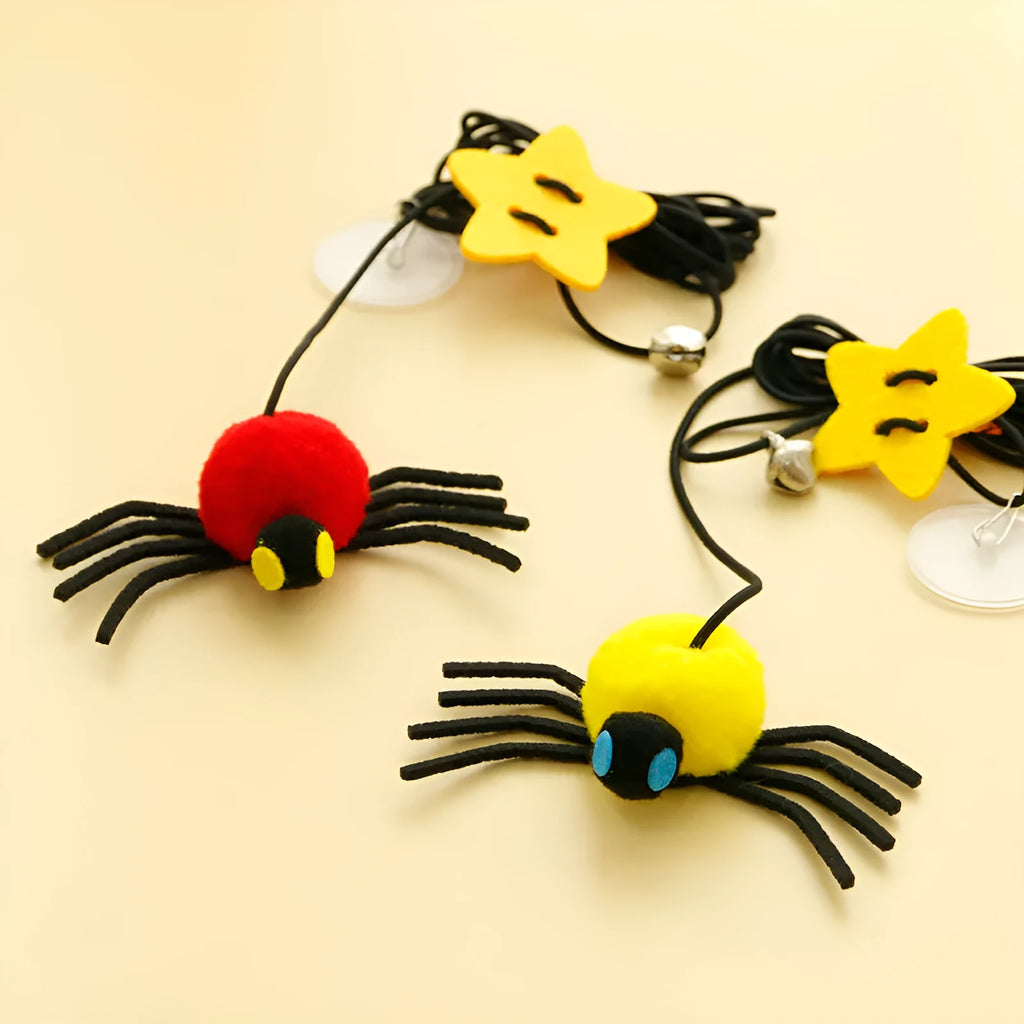 Red cat hanging door toy with elastic rope, feather, bell, and spider decoration